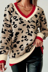 Front close view of beige leopard print sweater with red and cream V neckline.