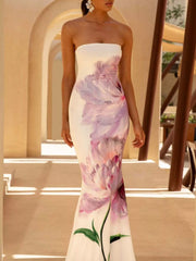 Model wearing strapless white and purple floral tube maxi dress, front view outdoors