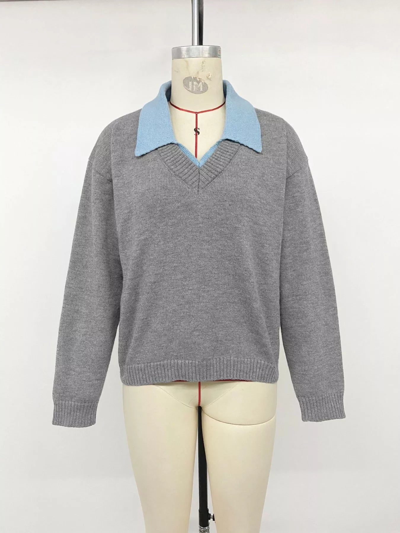 Front view of the gray contrast collar sweater displayed on a dress form