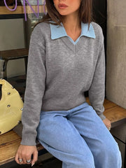 Seated angled view of the gray sweater with a light blue contrast collar and jeans