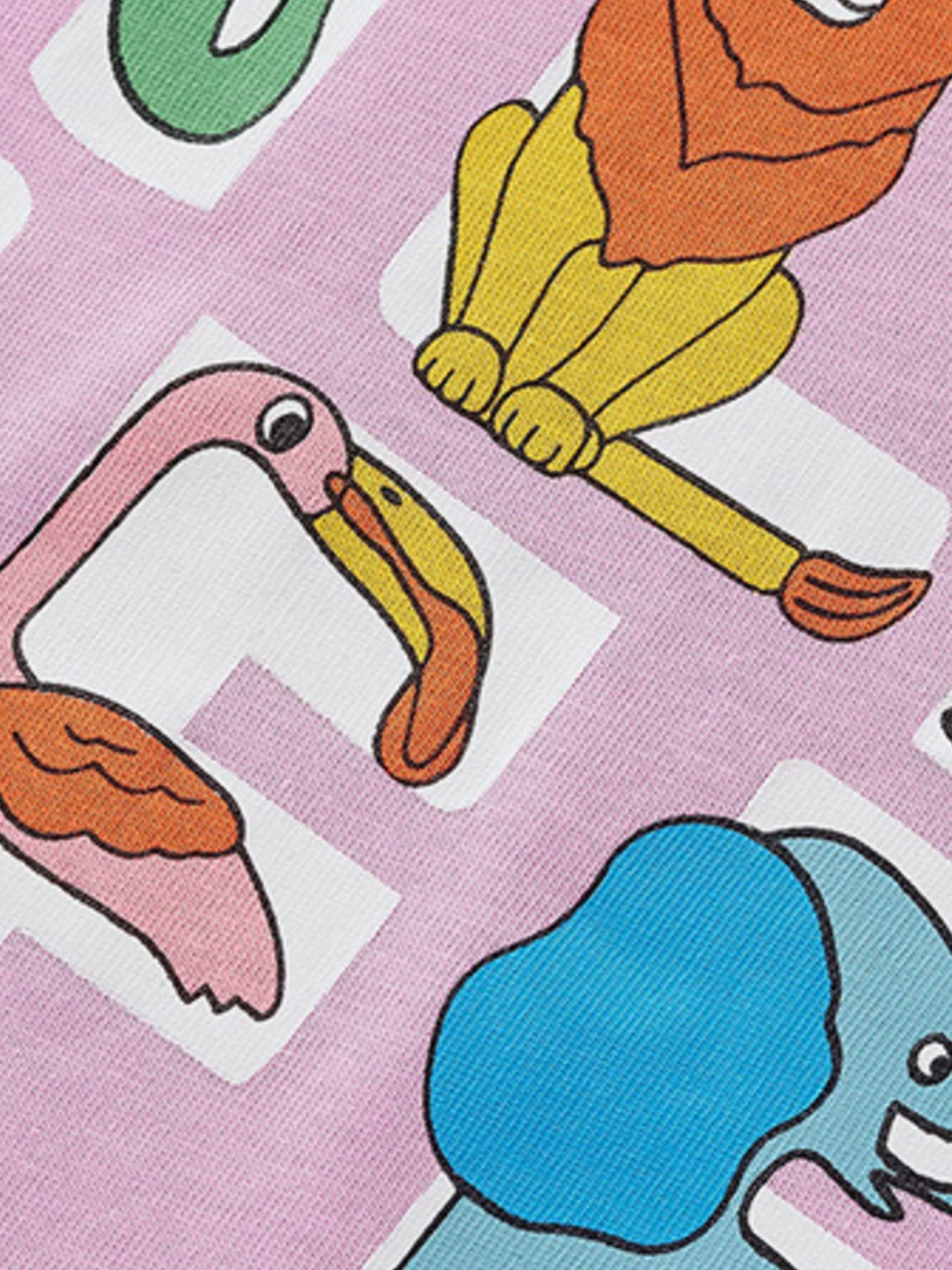 Close-up of the wild life graphic showing a flamingo, lion and elephant on a pink tee