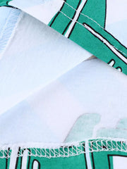 Close-up of the hem stitching detail and green vehicle print on a children's T-shirt