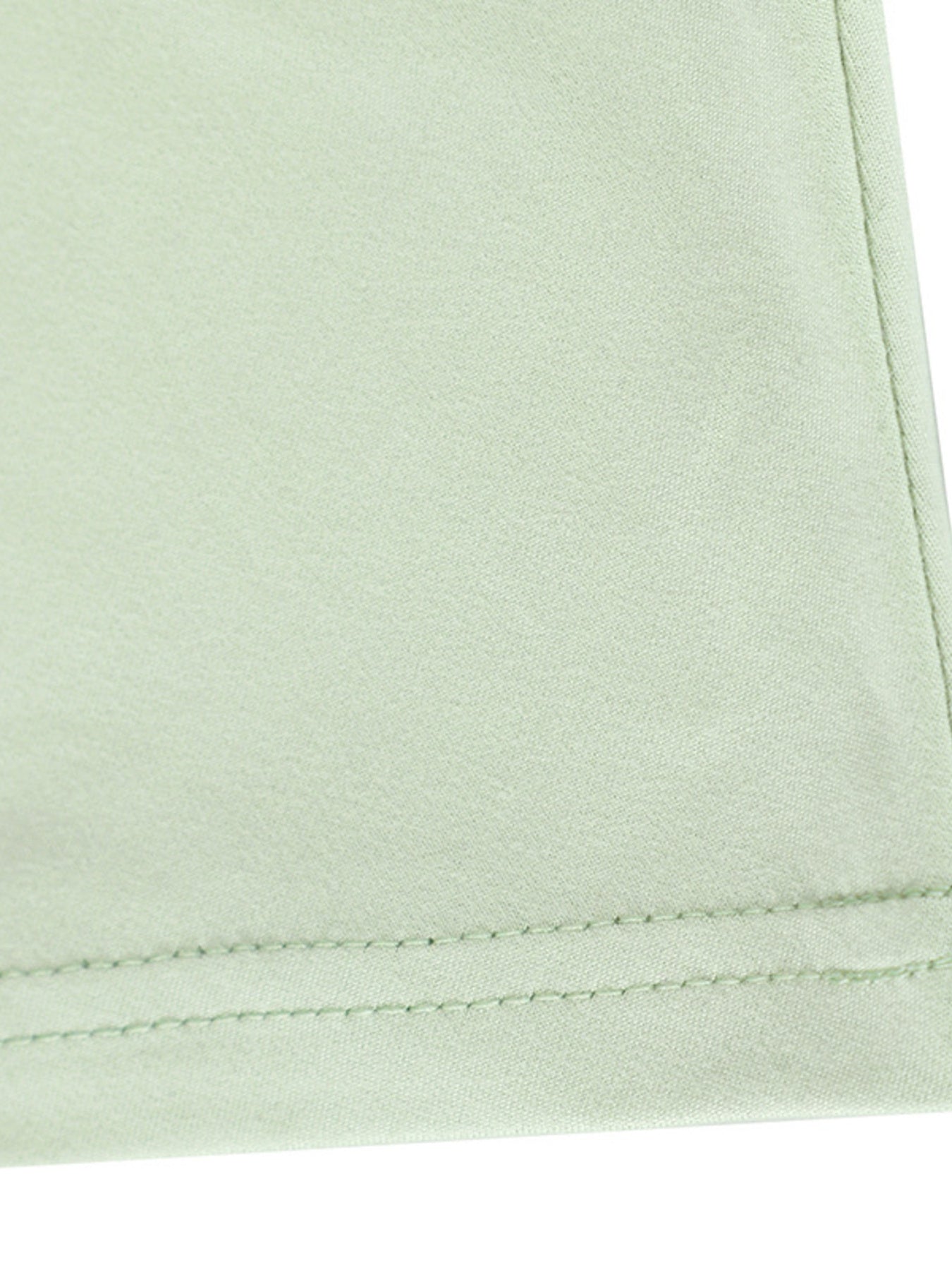 Close view of light green hem stitching on a floral bodycon mermaid maxi dress