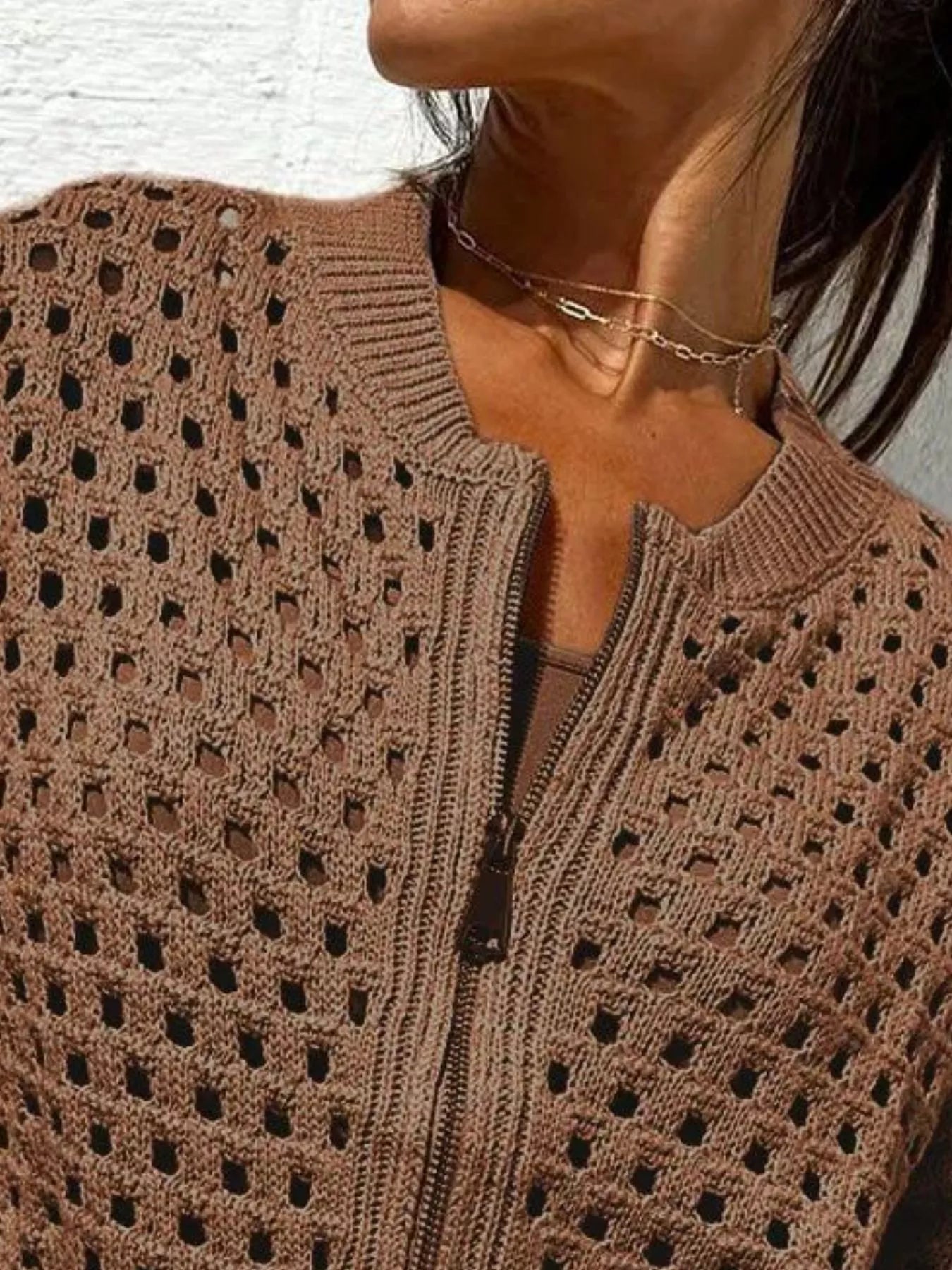 Close up of the dark brown crochet cardigan upper zip and openwork pattern