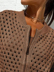 Close up of the dark brown crochet cardigan upper zip and openwork pattern