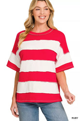 Women's red and cream striped short-sleeve top with exposed seam detailing, modeled with jeans.
