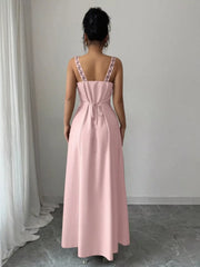 Back view of dusty pink sleeveless maxi dress with tied waist and patterned straps