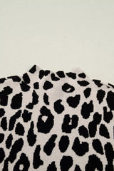 Close up detail of the high neckline and leopard print knit on the cream and black sweater.