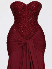 Red strapless sequin corset bodice and knotted draped waist, close detail view