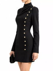 Side view of model in studio wearing black mock neck mini dress with gold decorative buttons