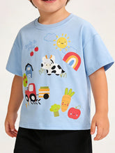 Front view of light blue children's T-shirt with a cartoon cow, tractor, rainbow and barn print