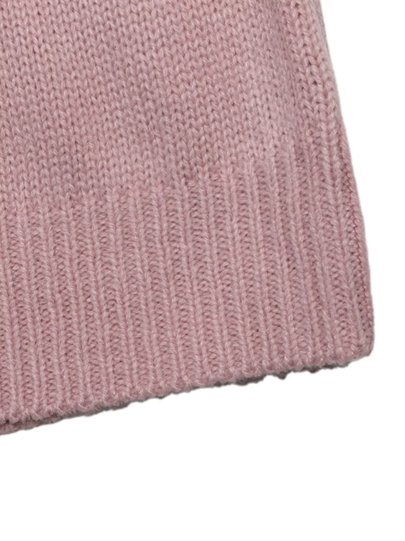 Close up of the pink sweater ribbed hem and fine knit texture.
