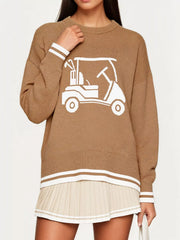 Front view of the khaki dropped shoulder sweater with a white golf cart graphic, hand at neckline.
