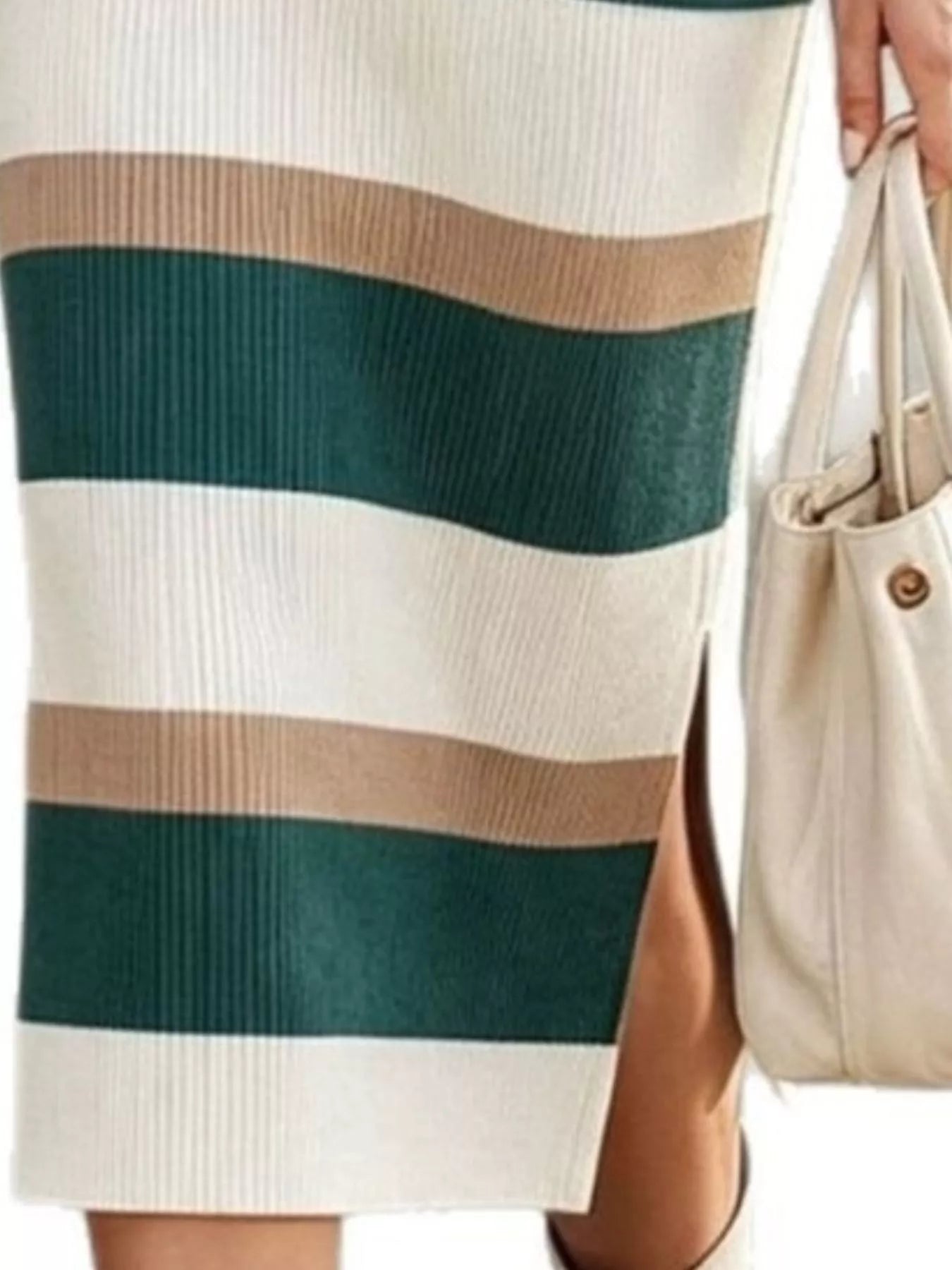 Closeup of green striped sweater dress skirt showing ribbed knit and side slit