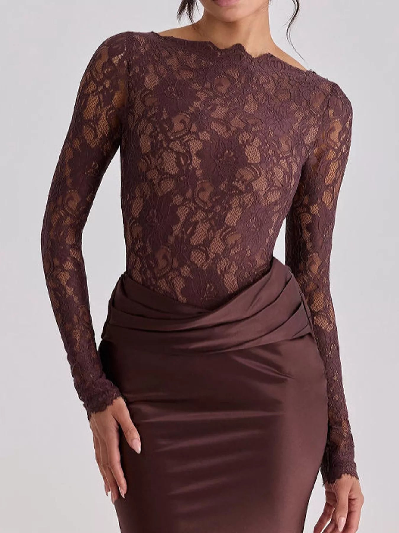 Close view of dark red floral lace bodice and draped satin waist on maxi dress