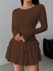 Coffee layered ruffle mini dress worn front facing with hands clasped at the waist
