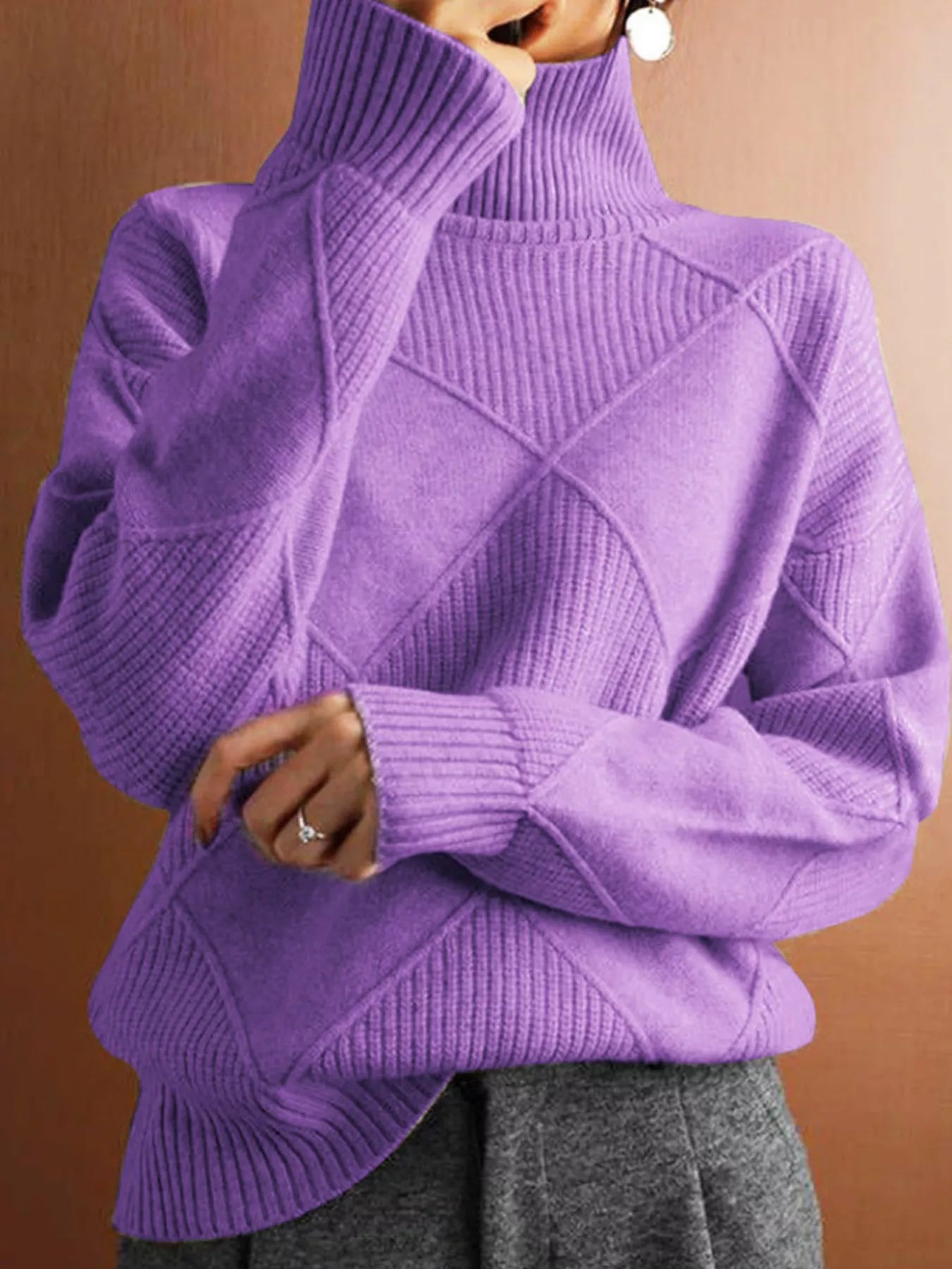 Front torso view of a lavender turtleneck sweater with a tonal diamond pattern