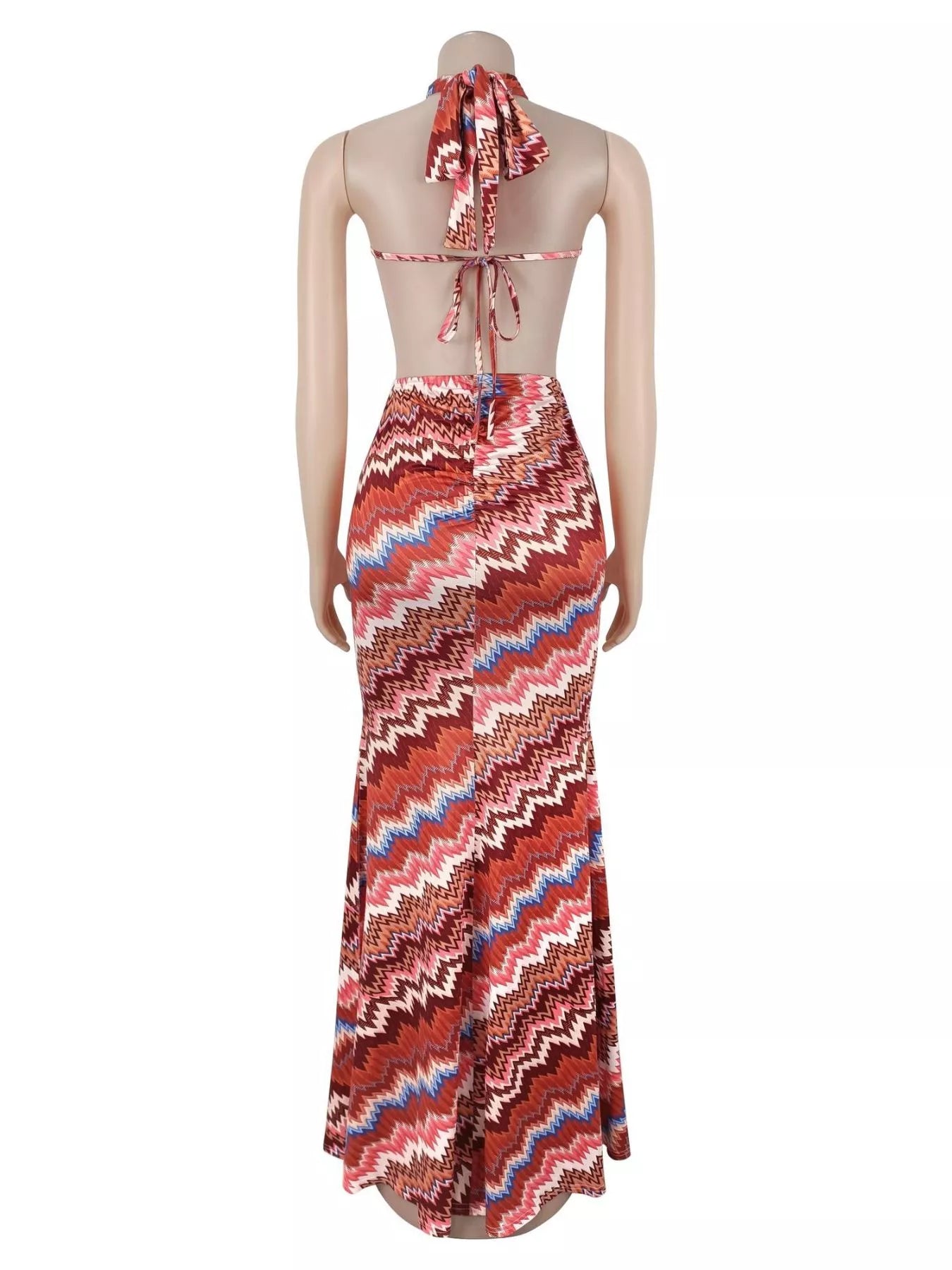 Back view of rust chevron maxi dress on a mannequin with tied halter straps