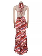 Back view of rust chevron maxi dress on a mannequin with tied halter straps