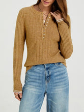 Close-up on-model front view of mustard ribbed knit top with pearl button placket and striped cuffs
