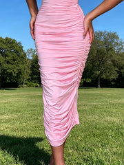 Close view of pink ruched tube bodycon midi dress skirt showing ruched fabric