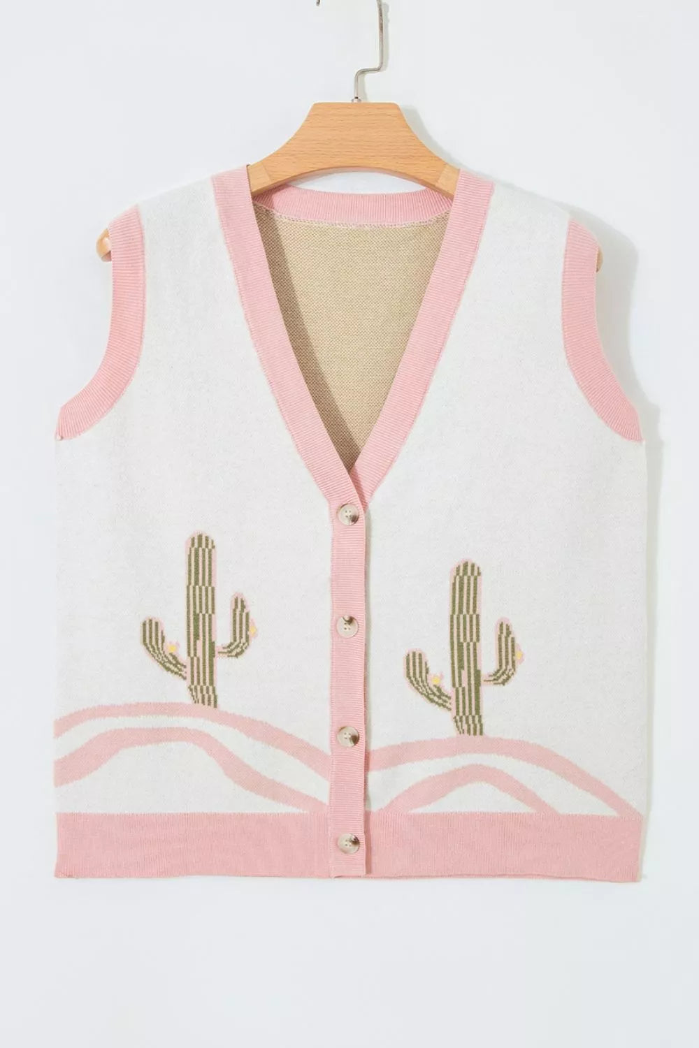 Front view of the cream cactus sweater vest with pink trim hanging on a hanger