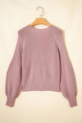 Flat lay back view of a dusty pink V-neck cardigan on a hanger with textured sleeves