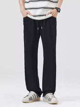 Men's black wide-leg casual pants with a drawstring waist.