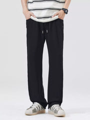 Men's black wide-leg casual pants with a drawstring waist.