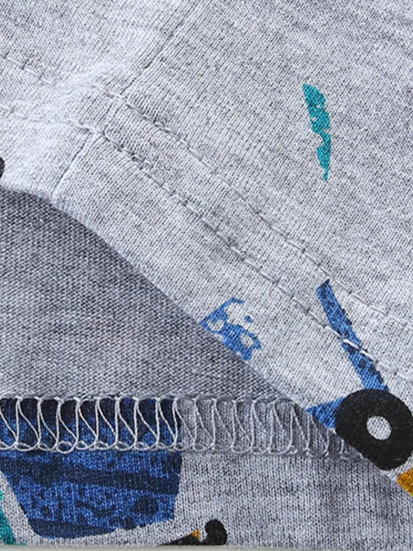 Close view of hem stitching on a gray children's excavator print short sleeve tee