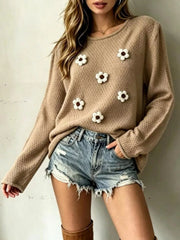Front view of a khaki textured knit sweater with white floral appliques and long sleeves