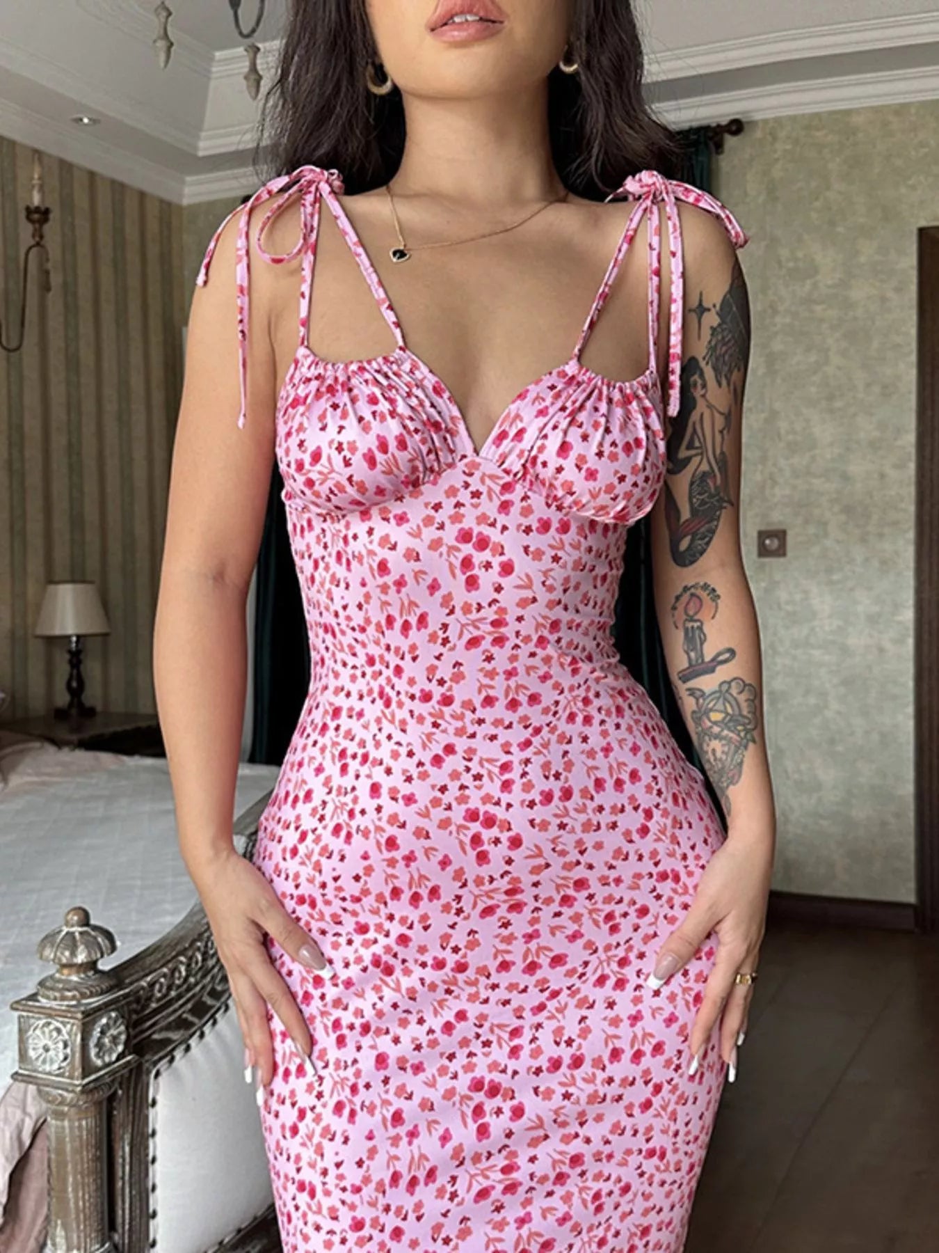 Close up of pink floral print bodycon maxi dress bodice with tie straps and ruched neckline
