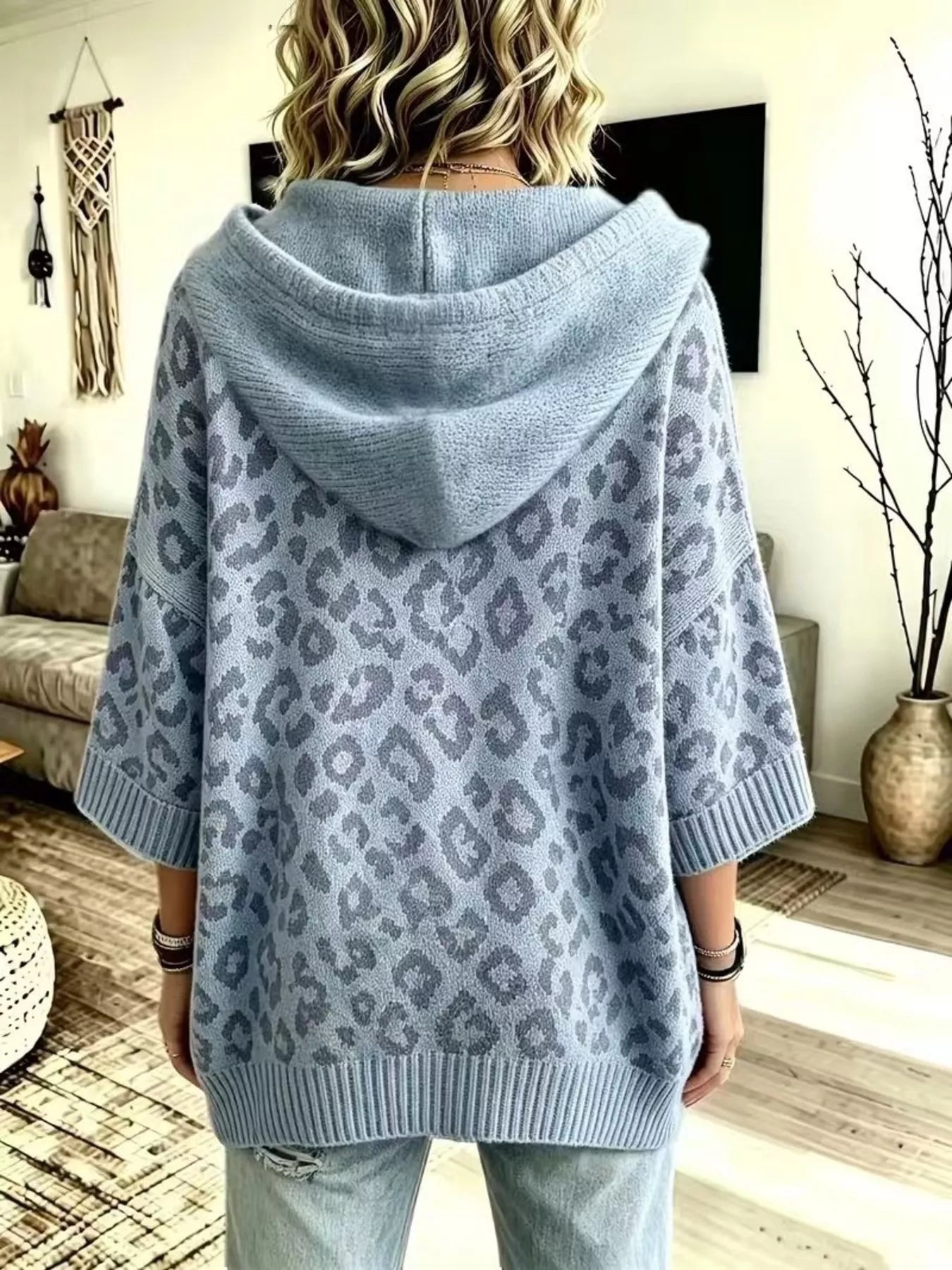Back view of dusty blue leopard print oversized hooded knit sweater with solid hood