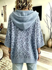 Back view of dusty blue leopard print oversized hooded knit sweater with solid hood