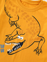 Close-up detail of the cartoon alligator head with open jaws on tangerine fabric