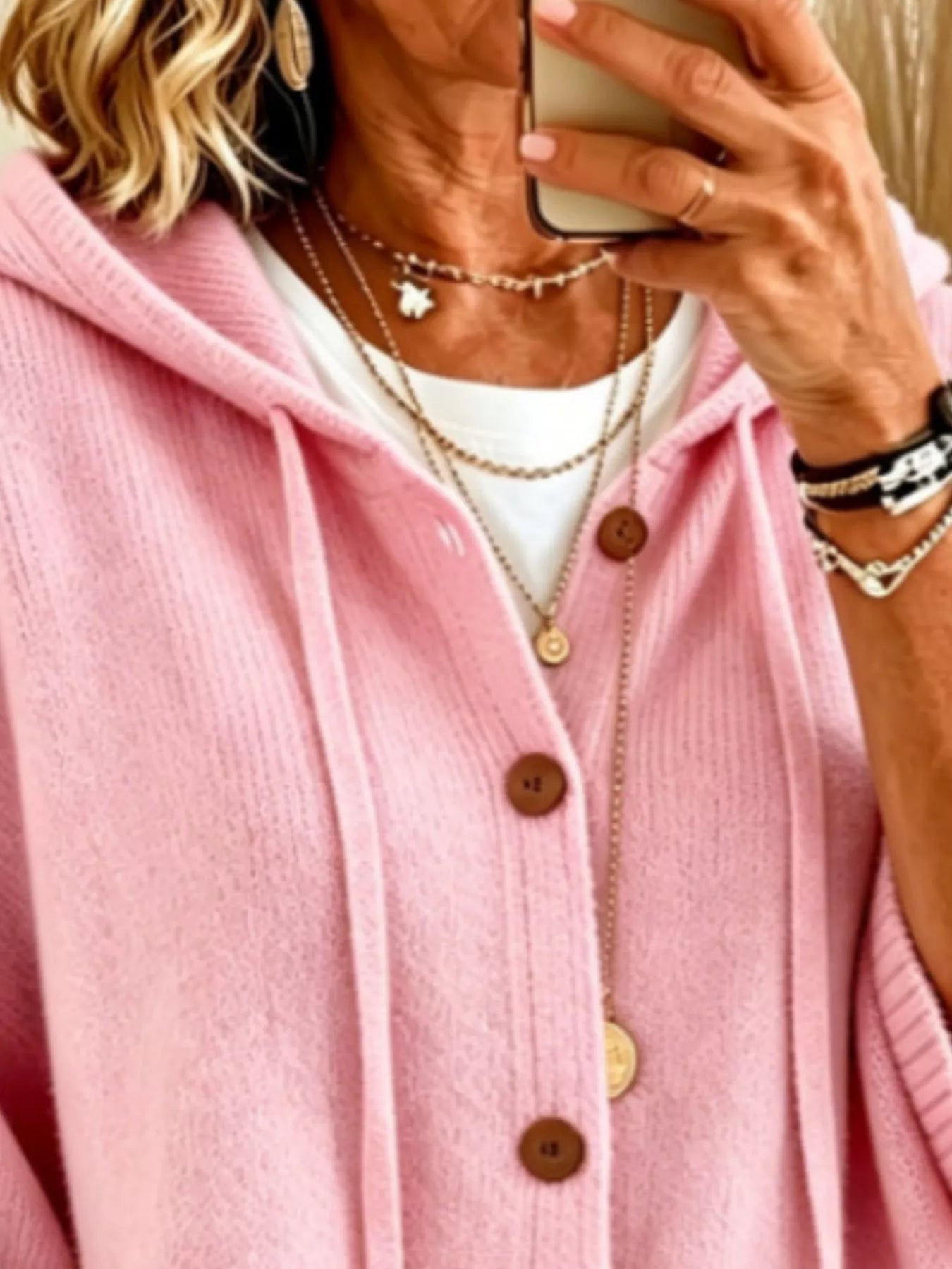 Close view of the pink hooded cardigan showing drawstrings and button front