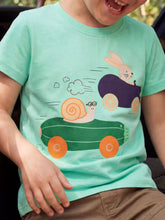 Green children's short sleeve T-shirt shown worn with a snail and bunny racing in vegetable cars