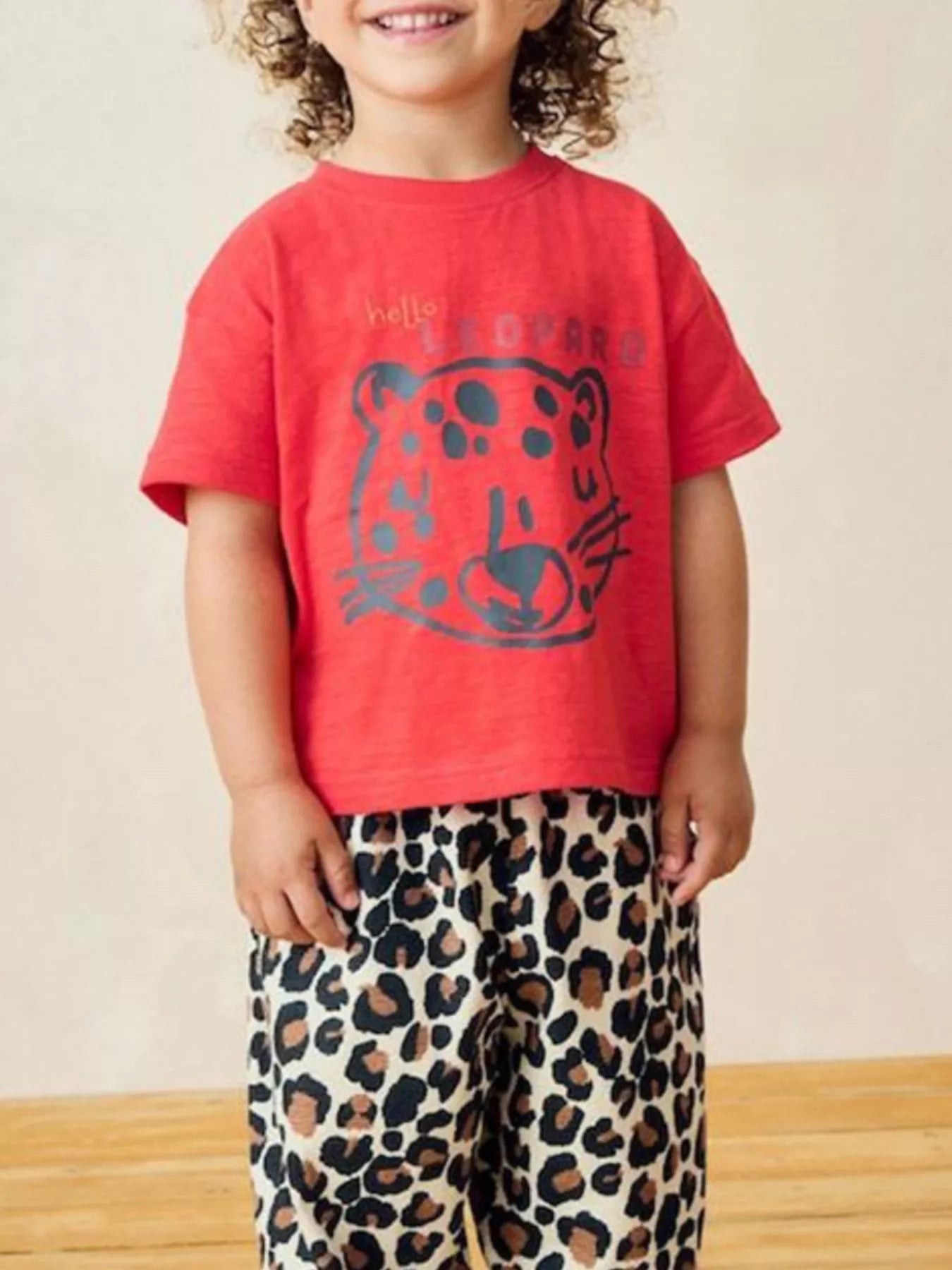 Children's red short-sleeve T-shirt featuring a leopard graphic design.