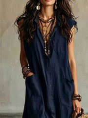 Close view of navy sleeveless button down linen maxi dress showing buttons and large pockets