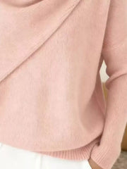 Close-up of the pale pink sweater lower body and long sleeve showing the ribbed hem and knit texture