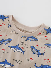 Detail view of the ribbed crew neckline on a children's shark print t-shirt with blue sharks