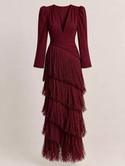 Flat front view of a burgundy fringed maxi dress with puff sleeves and tiered fringe