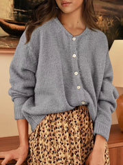 Front view of gray button down cardigan with white buttons paired with a leopard print skirt