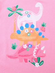 Close up of pink children's t-shirt print with three dinosaurs flowers and palm trees