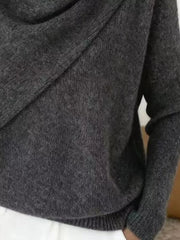Close-up of the dark gray sweater lower body and long sleeve showing the ribbed hem and knit texture