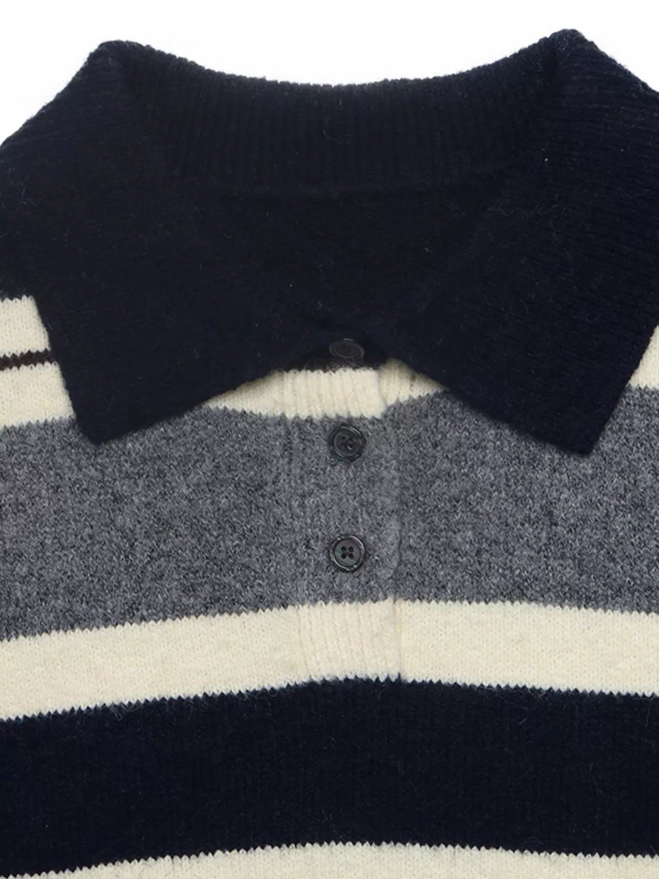 Close-up of the navy polo collar and button placket on the striped knit sweater