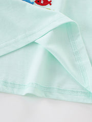 Close view of the mint children's tee hem and sleeve seam showing fine overlock stitching