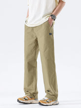 Men's khaki wide-leg casual pants with a polyester-blend composition.
