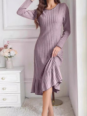 Light purple ribbed knit bodycon dress with ruffle hem worn indoors, front view lifting the skirt