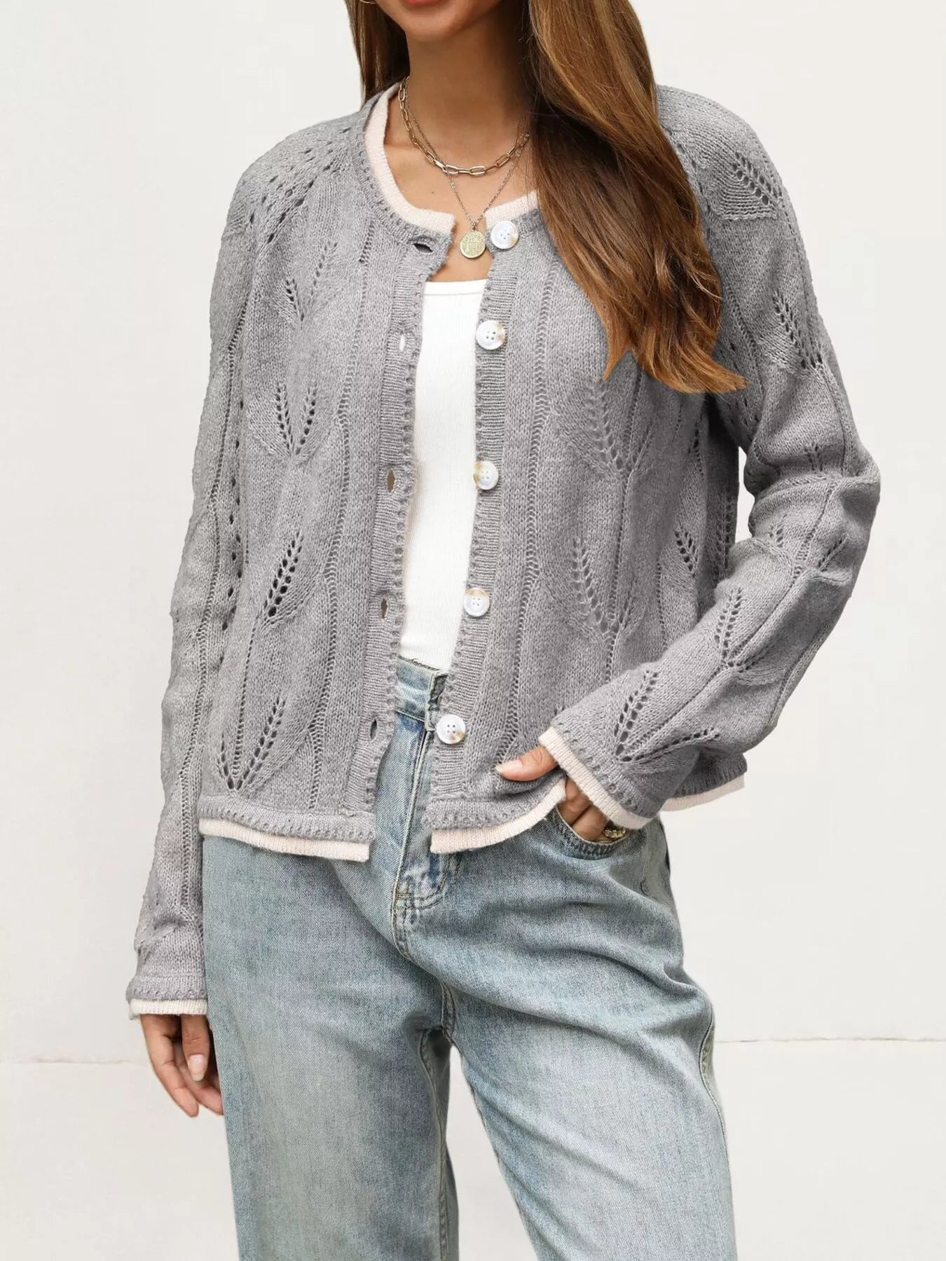 Gray hollow out knit cardigan with leaf pattern worn open